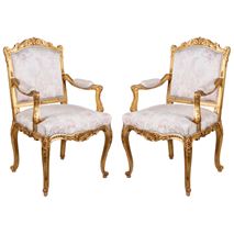 A pair of Louis XVI style gilded arm chairs by ' Mellier'