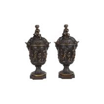 Pair classical 19th Century Bacchus lidded bronze urns.