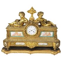 French 19th Century mantel clock recling putti and Sevres panels.