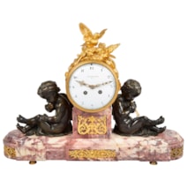 Louis XVI style mantel clock with bronze cherubs.