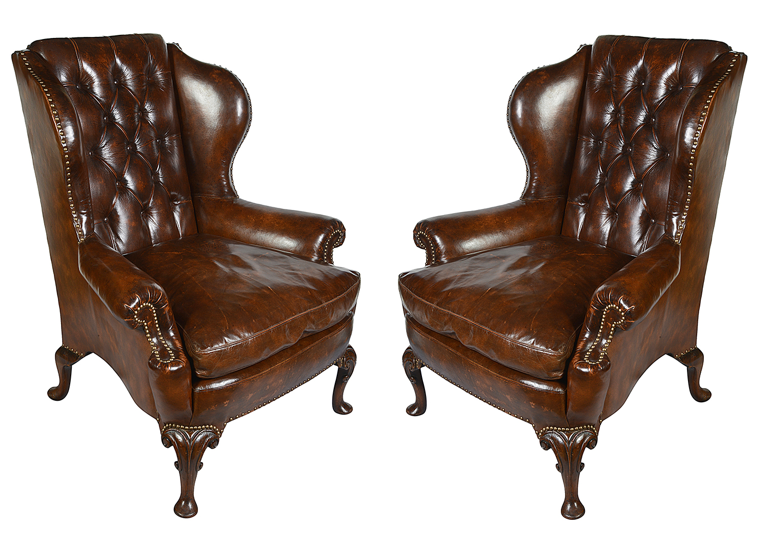 Pair Georgian style leather button back arm chairs.