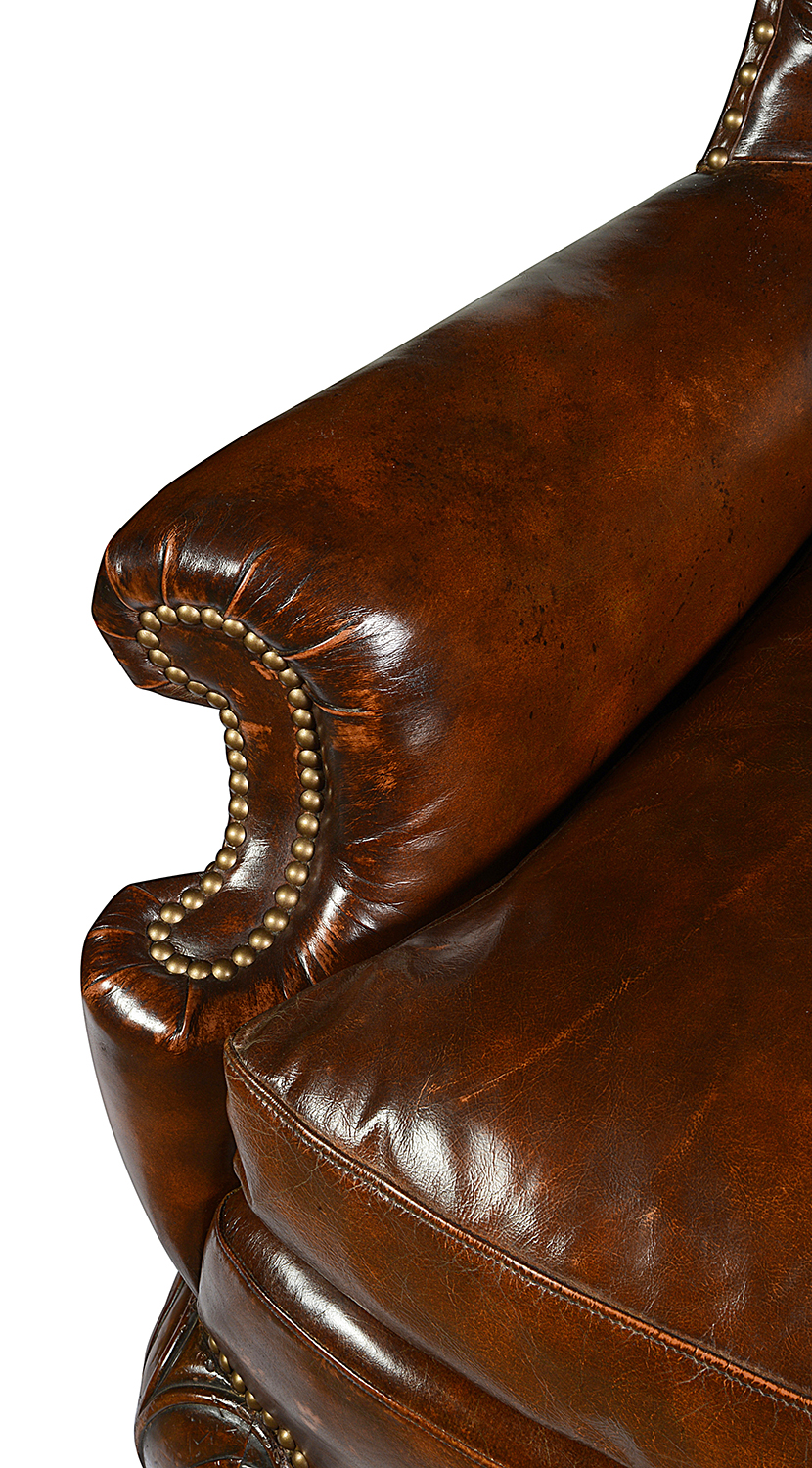 Pair Georgian style leather button back arm chairs.